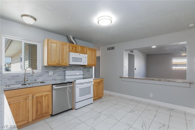 6317 Alta Dr, Las Vegas, NV 89107 - kitchen featuring white appliances, light marble finish flooring, tasteful backsplash, and light stone counters