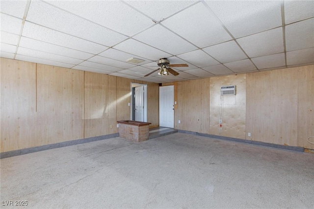 6317 Alta Dr, Las Vegas, NV 89107 - carpeted empty room featuring ceiling fan, a wall mounted air conditioner, a paneled ceiling, and wooden walls