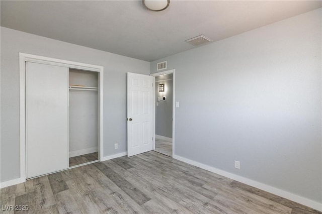 6317 Alta Dr, Las Vegas, NV 89107 - unfurnished bedroom featuring wood finished floors and a closet