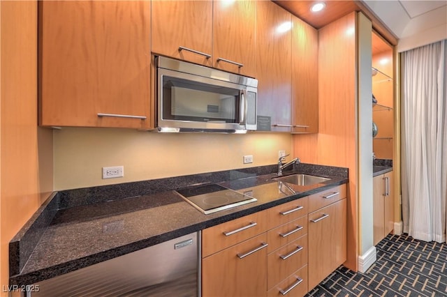 2000 Fashion Show Dr Unit 4105-4106, Las Vegas, NV 89109 - kitchen featuring stainless steel microwave, black electric stovetop, and brown cabinets