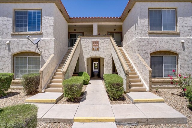 5112 Harvest Time St Unit 201, Las Vegas, NV 89130 - view of front of house with stairway, stucco siding, and a tile roof