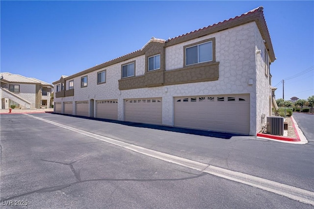 5112 Harvest Time St Unit 201, Las Vegas, NV 89130 - view of front of property with a tiled roof, stucco siding, and stone siding