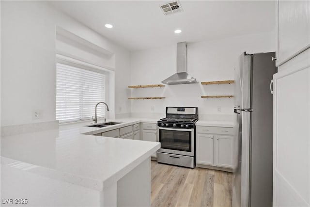 5112 Harvest Time St Unit 201, Las Vegas, NV 89130 - kitchen featuring stainless steel appliances, open shelves, wall chimney range hood, a peninsula, and light countertops