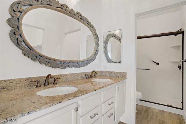 5112 Harvest Time St Unit 201, Las Vegas, NV 89130 - full bath featuring double vanity, a shower stall, and wood finished floors