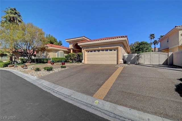 4936 Mountain Foliage Dr, Las Vegas, NV 89148 - mediterranean / spanish-style home with a gate, driveway, a garage, a tiled roof, and stucco siding