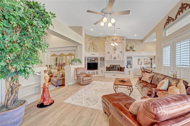 4936 Mountain Foliage Dr, Las Vegas, NV 89148 - living area with a ceiling fan, wood finished floors, a glass covered fireplace, and recessed lighting