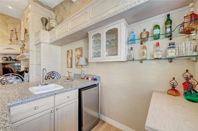 4936 Mountain Foliage Dr, Las Vegas, NV 89148 - kitchen with fridge, white cabinetry, glass insert cabinets, light stone countertops, and light wood finished floors