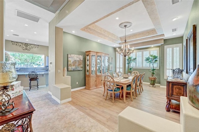 4936 Mountain Foliage Dr, Las Vegas, NV 89148 - dining room with healthy amount of natural light, a chandelier, recessed lighting, a tray ceiling, and wood finished floors