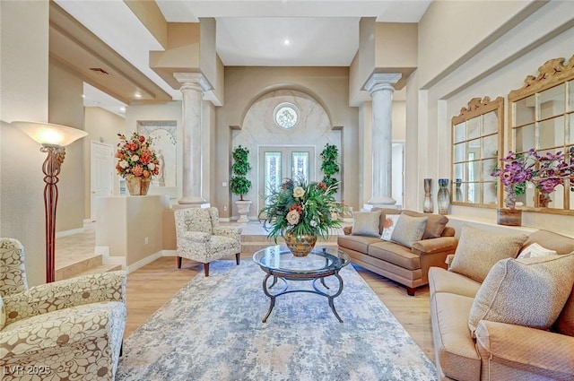 4936 Mountain Foliage Dr, Las Vegas, NV 89148 - living room featuring decorative columns and light wood-style floors