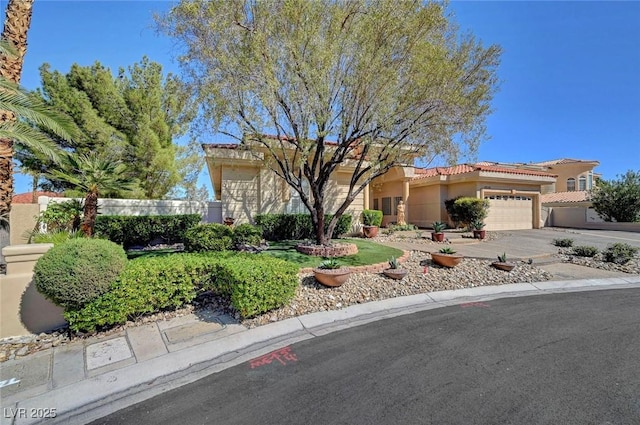 4936 Mountain Foliage Dr, Las Vegas, NV 89148 - view of front of property with an attached garage, a tiled roof, stucco siding, and concrete driveway