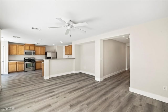 5824 Gemstone Peak St, North Las Vegas, NV 89031 - kitchen featuring appliances with stainless steel finishes, recessed lighting, open floor plan, light wood finished floors, and light countertops