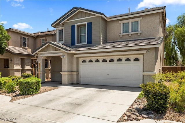 5824 Gemstone Peak St, North Las Vegas, NV 89031 - traditional home with a garage, concrete driveway, stucco siding, a tile roof, and board and batten siding