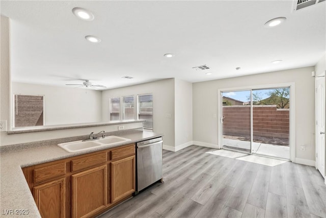 5824 Gemstone Peak St, North Las Vegas, NV 89031 - kitchen with stainless steel dishwasher, brown cabinetry, a ceiling fan, recessed lighting, and light wood finished floors