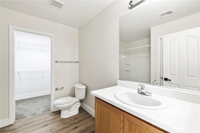 5824 Gemstone Peak St, North Las Vegas, NV 89031 - bathroom featuring vanity, wood finished floors, a shower, and a spacious closet