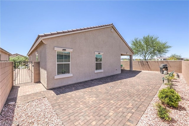 326 Zenith Crest St, Henderson, NV 89015 - back of property with a fenced backyard, stucco siding, a patio, and a gate