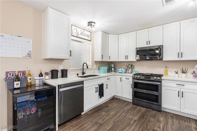 824 Antigua St, Las Vegas, NV 89145 - kitchen with stainless steel appliances, beverage cooler, light countertops, and dark wood-style floors