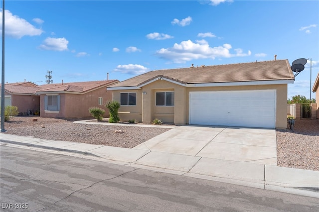 2111 Hollow Oak Ave, North Las Vegas, NV 89031 - ranch-style home featuring concrete driveway, stucco siding, an attached garage, and a tiled roof