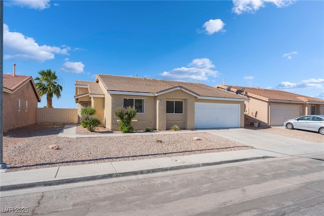 2111 Hollow Oak Ave, North Las Vegas, NV 89031 - single story home with an attached garage, stucco siding, concrete driveway, and a tiled roof