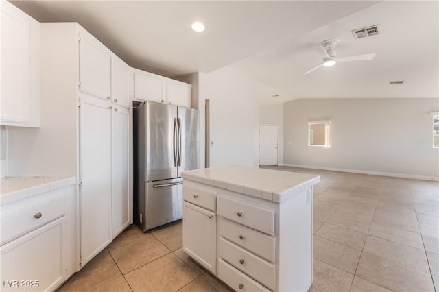 2111 Hollow Oak Ave, North Las Vegas, NV 89031 - kitchen featuring freestanding refrigerator, tile countertops, light tile patterned flooring, lofted ceiling, and ceiling fan