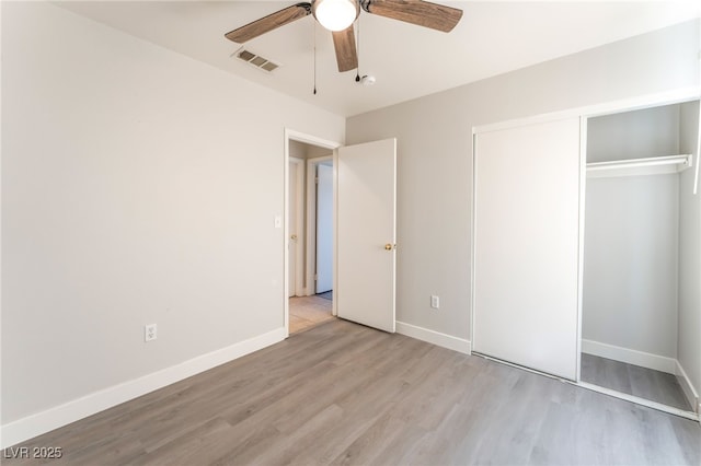 2111 Hollow Oak Ave, North Las Vegas, NV 89031 - unfurnished bedroom with wood finished floors, a closet, and a ceiling fan