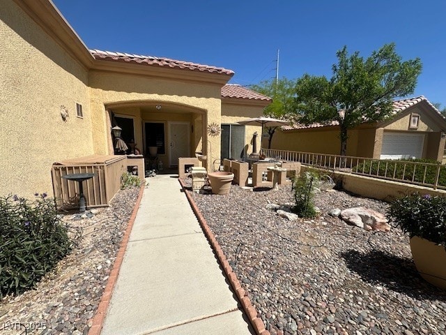 9816 Villa Ridge Dr, Las Vegas, NV 89134 - property entrance featuring stucco siding, a tiled roof, and a patio