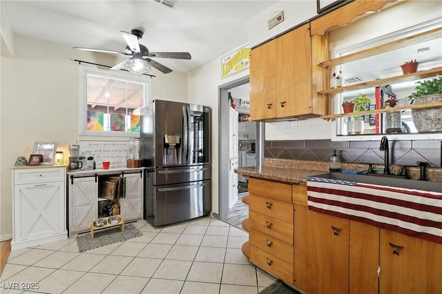 517 5th St, Boulder City, NV 89005 - kitchen with stainless steel fridge, backsplash, ceiling fan, and light tile patterned floors