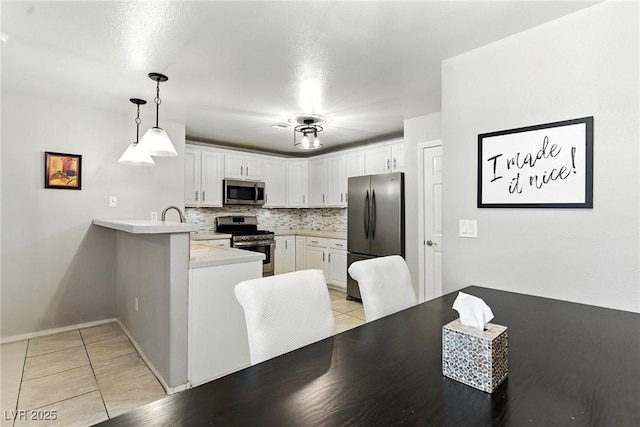 620 Painted Cloud Pl, Las Vegas, NV 89144 - kitchen with stainless steel appliances, a peninsula, light tile patterned flooring, light countertops, and tasteful backsplash