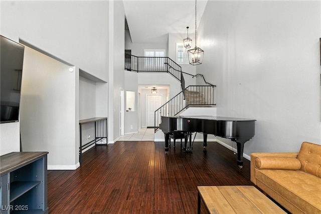 620 Painted Cloud Pl, Las Vegas, NV 89144 - living room with stairs, a towering ceiling, hardwood / wood-style floors, and a chandelier