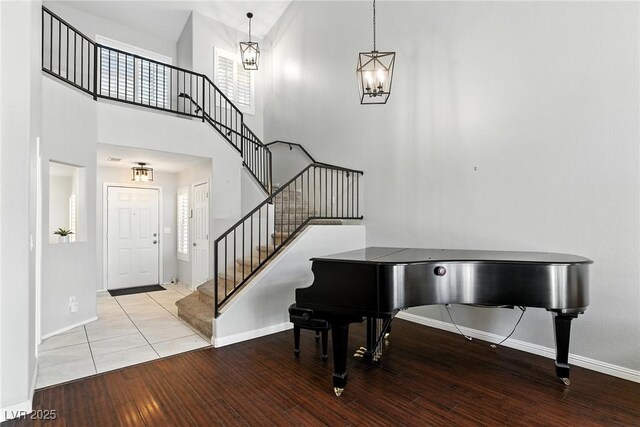 620 Painted Cloud Pl, Las Vegas, NV 89144 - foyer with wood finished floors, stairs, a high ceiling, and a chandelier