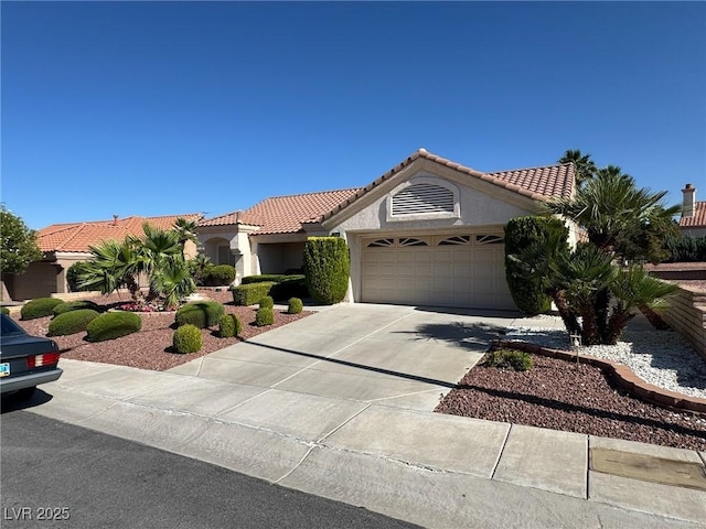 9505 Quail Ridge Dr, Las Vegas, NV 89134 - mediterranean / spanish-style house featuring an attached garage, concrete driveway, stucco siding, and a tiled roof