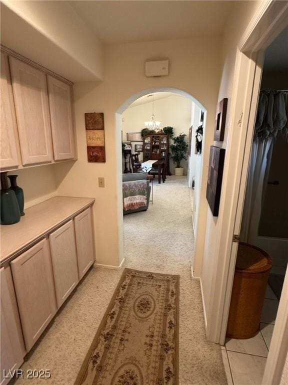 9505 Quail Ridge Dr, Las Vegas, NV 89134 - corridor with arched walkways and a chandelier