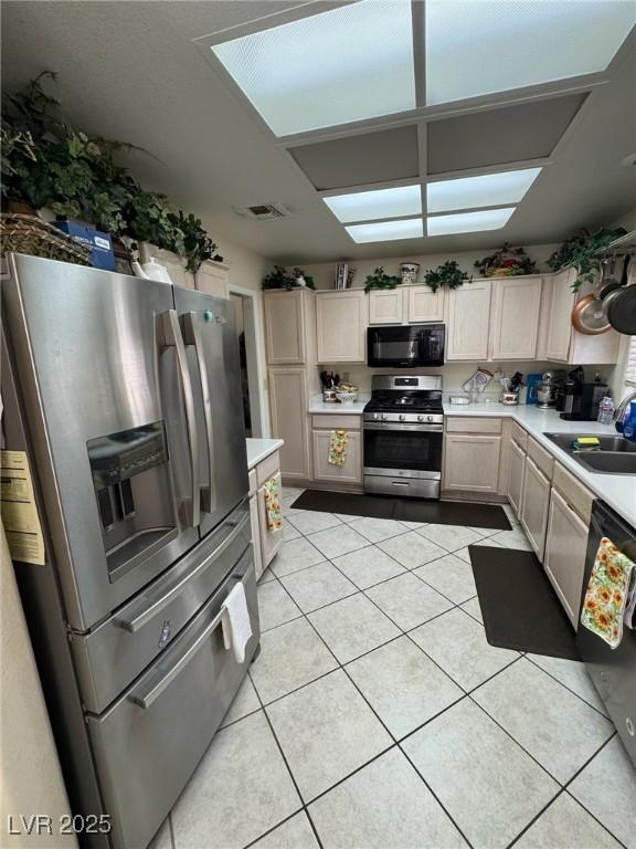 9505 Quail Ridge Dr, Las Vegas, NV 89134 - kitchen featuring appliances with stainless steel finishes, light countertops, and light tile patterned flooring