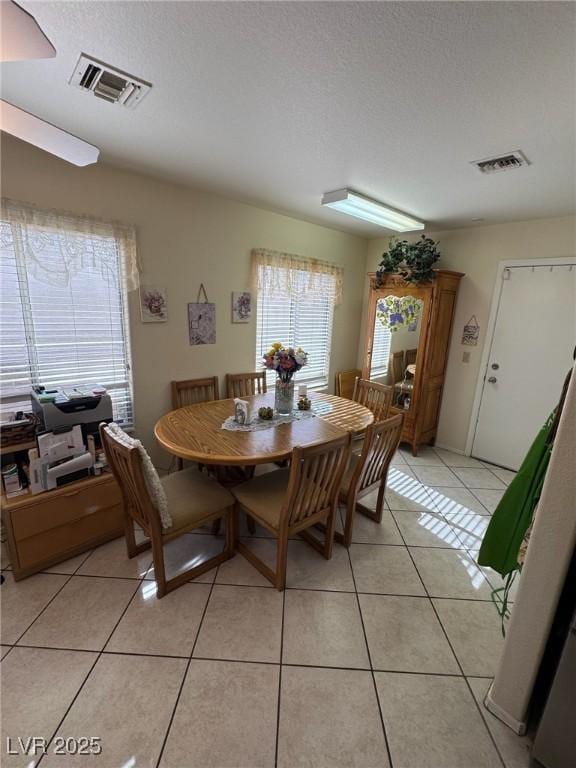 9505 Quail Ridge Dr, Las Vegas, NV 89134 - dining room with light tile patterned floors and a textured ceiling