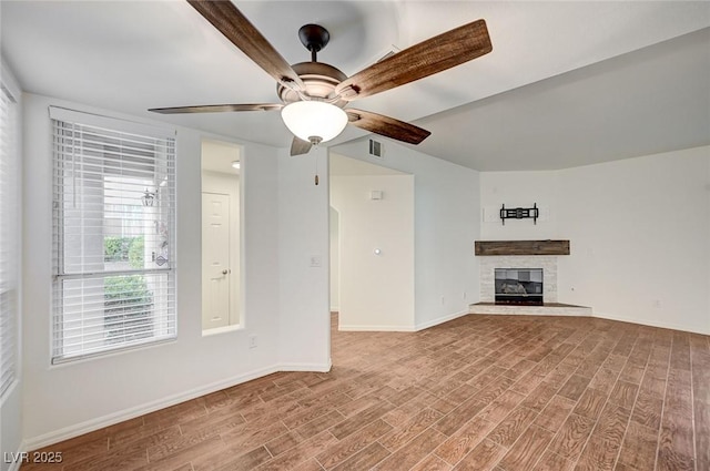 2050 W Warm Springs Rd Unit 4512, Henderson, NV 89014 - unfurnished living room with wood finished floors, a fireplace, and a ceiling fan
