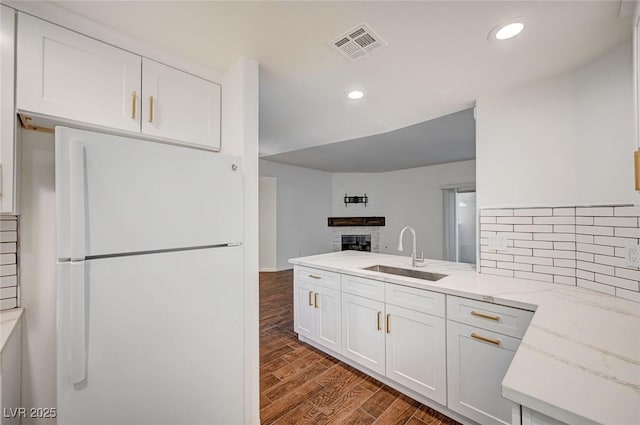 2050 W Warm Springs Rd Unit 4512, Henderson, NV 89014 - kitchen featuring freestanding refrigerator, dark wood-style floors, white cabinetry, open floor plan, and backsplash