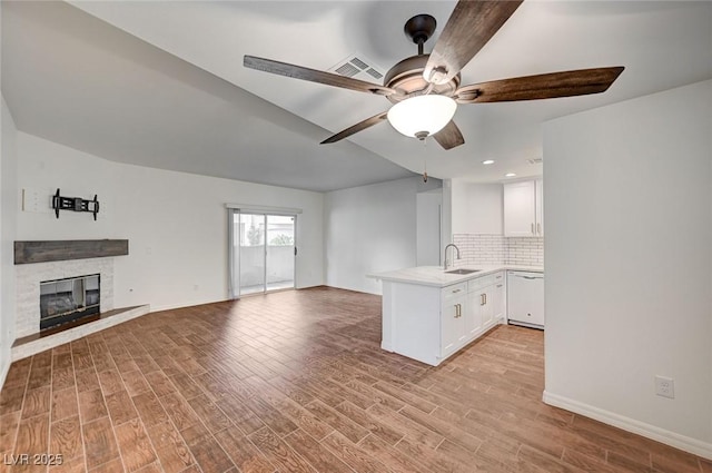 2050 W Warm Springs Rd Unit 4512, Henderson, NV 89014 - unfurnished living room featuring light wood-style flooring, ceiling fan, a glass covered fireplace, and recessed lighting