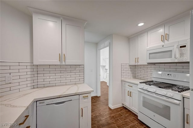 2050 W Warm Springs Rd Unit 4512, Henderson, NV 89014 - kitchen with white appliances, white cabinets, dark wood-type flooring, recessed lighting, and light stone countertops