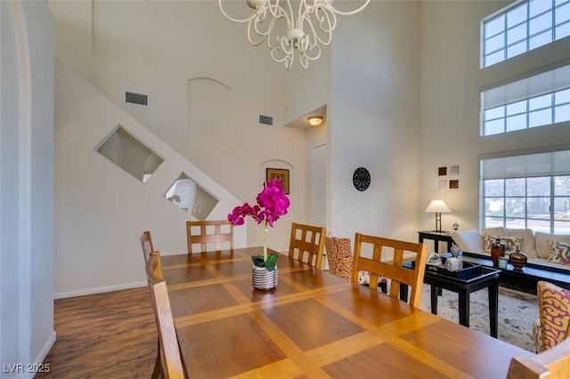 10952 Porto Foxi St, Las Vegas, NV 89141 - dining space with a towering ceiling, plenty of natural light, wood finished floors, and a chandelier