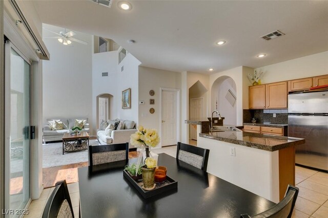 10952 Porto Foxi St, Las Vegas, NV 89141 - kitchen with freestanding refrigerator, arched walkways, a ceiling fan, tasteful backsplash, and recessed lighting