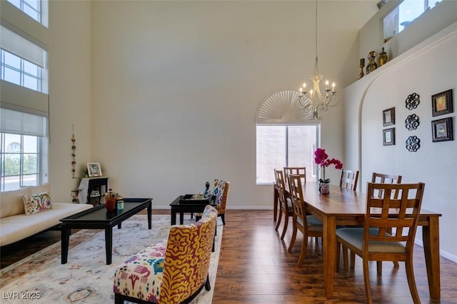 10952 Porto Foxi St, Las Vegas, NV 89141 - dining room featuring a high ceiling, plenty of natural light, wood finished floors, and a chandelier