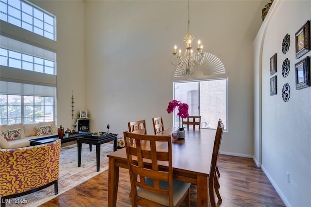 10952 Porto Foxi St, Las Vegas, NV 89141 - dining space with a chandelier, a towering ceiling, and dark wood-style flooring