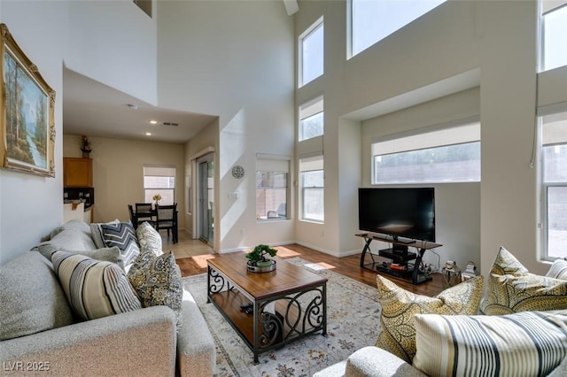 10952 Porto Foxi St, Las Vegas, NV 89141 - living area featuring light wood-style flooring, a high ceiling, and recessed lighting