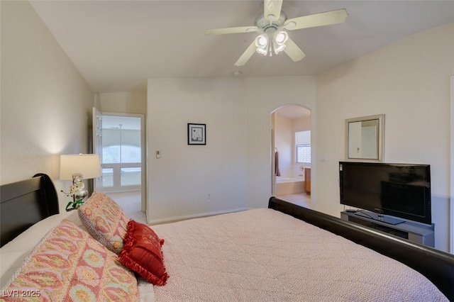 10952 Porto Foxi St, Las Vegas, NV 89141 - bedroom featuring arched walkways, multiple windows, carpet, and ensuite bath
