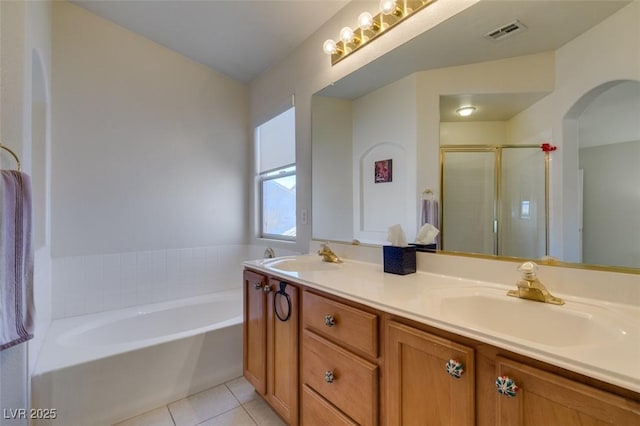 10952 Porto Foxi St, Las Vegas, NV 89141 - bathroom with tile patterned floors, double vanity, a bath, and a shower stall