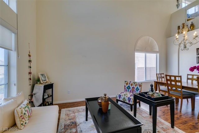 10952 Porto Foxi St, Las Vegas, NV 89141 - living room with a high ceiling, healthy amount of natural light, a chandelier, and wood finished floors