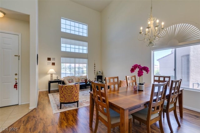 10952 Porto Foxi St, Las Vegas, NV 89141 - dining area featuring a chandelier, wood finished floors, and a high ceiling