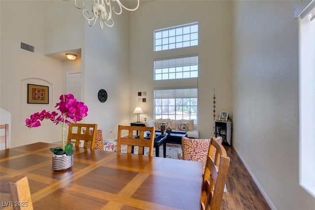 10952 Porto Foxi St, Las Vegas, NV 89141 - dining space with a towering ceiling, wood finished floors, and a chandelier