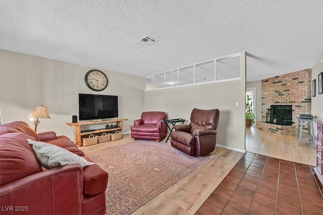 7113 Carrondale Way, Las Vegas, NV 89128 - living area featuring wood finished floors, a fireplace, and a textured ceiling