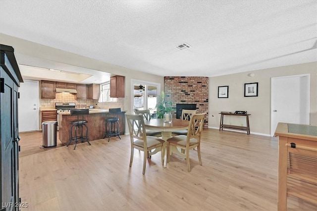 7113 Carrondale Way, Las Vegas, NV 89128 - dining area featuring a textured ceiling and light wood-style flooring