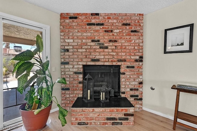 7113 Carrondale Way, Las Vegas, NV 89128 - detailed view of wood finished floors, a textured ceiling, and a fireplace